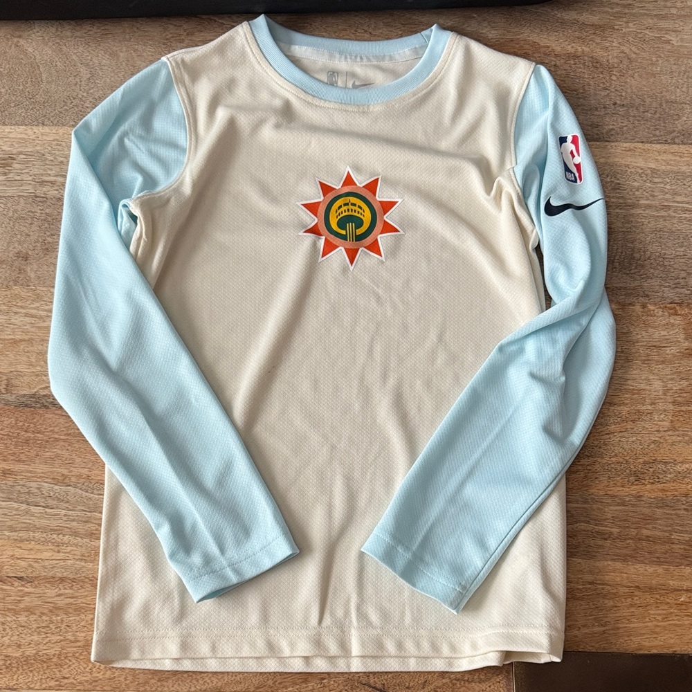 Nike / NBA Kids Beige and Light Blue Long Sleeve Shooting Shirt.